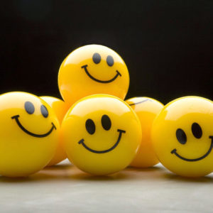 several balls that have a smile on them which indicates positive thinking