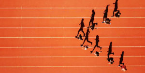A group of runners on the track running with their shadows nex to them which indicates agile leadership