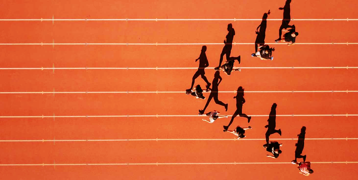 A group of runners on the track running with their shadows nex to them which indicates agile leadership